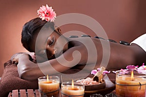 Woman undergoing lastone therapy at spa