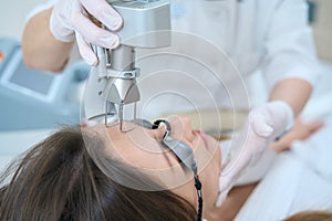 Woman undergoing a procedure for removing neoplasms with a laser