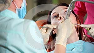 Woman undergoing teeth polishing in dental office