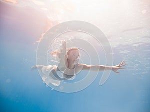 Woman underwater at the pool