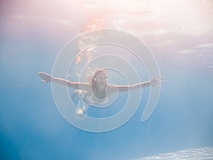 Woman underwater at the pool