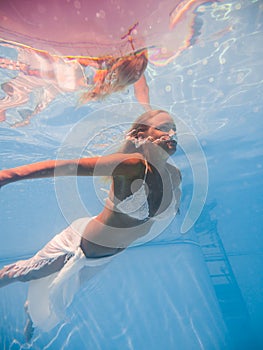 Woman underwater at the pool