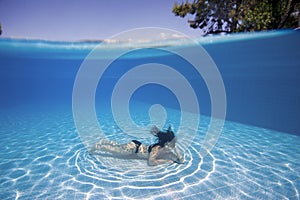 Woman underwater in a pool