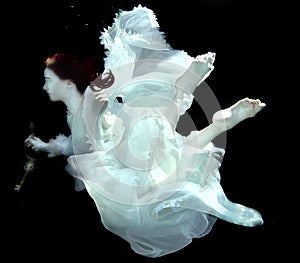 Woman Underwater Wearing White Gown