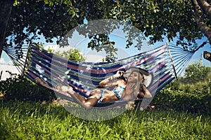 Woman in underwear has a rest in a hammock