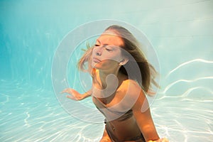 Woman undewater in the swimming pool