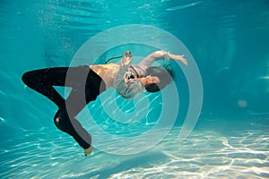Woman undewater in the swimming pool