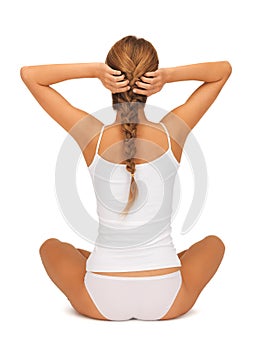 Woman in undrewear practicing yoga lotus pose