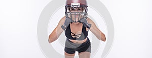 Woman in the uniform of an American football team player posing on a white background. Sports concept