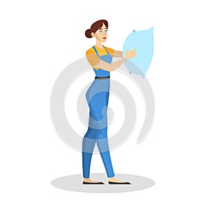 Woman in the uniform holding a pillow. Cleaning service