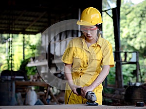 A woman in a uniform working in a technician is preparing to use the tools