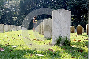 Woman at Unknown soldier`s grave with yellow flowers.