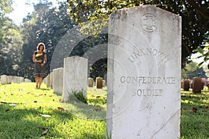 Woman at Unknown soldier`s grave with yellow flowers.