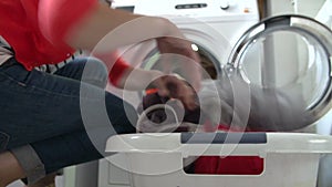 Woman Unloading Clothes From Washing Machine