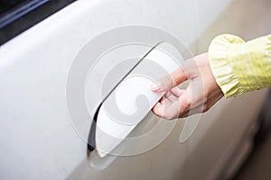 Woman unlock and open door of white car
