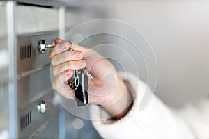 Woman unlocking apartment mailbox