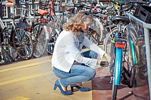 Woman unlocking the bicycle