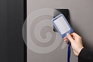 Woman unlocking door with key card, closeup