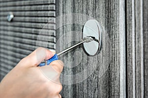 Woman unlocking door with key, closeup view