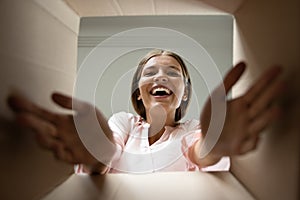 Woman unpack parcel closeup, view from bottom of box