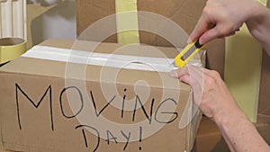 Woman unpacking cartons in her new house.Moving Day Concept