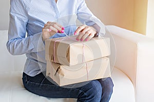 Woman unpacking delivery boxes with merchandise from online orders