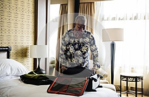 Woman unpacking her suitcase in hotel room