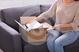 Woman Unpacking Received Parcel