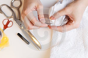 Woman unpick fabric on table
