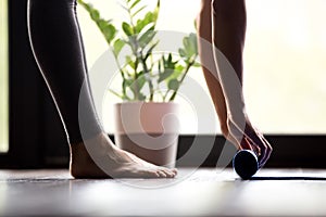 Woman unrolling yoga mat, close up view photo