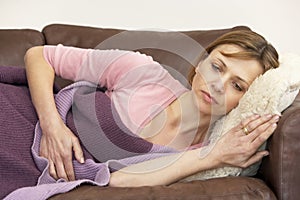 Woman Unwell And Lying On Sofa photo