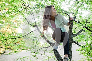 Woman up in the tree having fun time