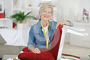 Woman upholstering chair