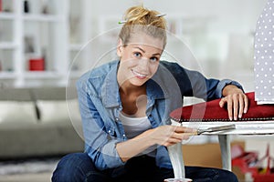 Woman upholstering chair in workshop