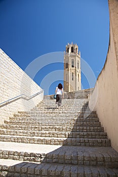 Woman upstairs to cathedral at Lleida city