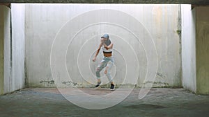 Woman, urban dance and hip hop street artist performance in energy, freedom and talent on wall background in Australia