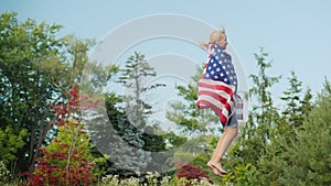 Woman with US flag jumping on trampoline on shoulders