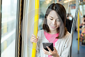 Woman use of cellphone inside train