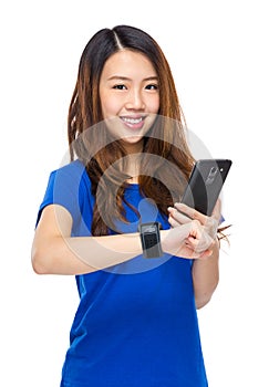 Woman use cellphone share date with wearable watch