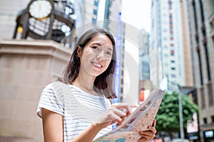 Woman use of city map in Hong Kong