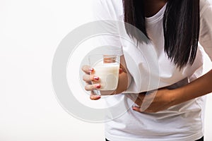 Woman use hand holding glass milk she is bad stomach ache