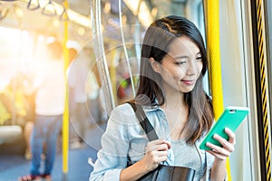 Woman use of mobile phone inside train compartment