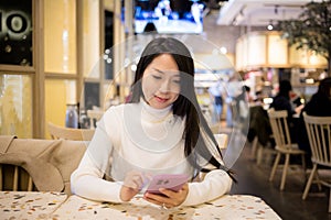 Woman use mobile phone order food at restaurant