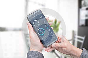 Woman use modern mobile app with modern flat design interface to control home security, lighting and air temperature