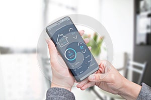 Woman use modern mobile app with modern flat design interface to control home security, lighting and air temperature photo