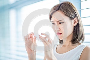 Woman use oil blotting paper