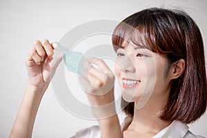 Woman use oil blotting paper