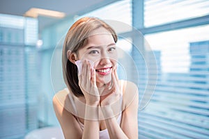 Woman use oil blotting paper photo