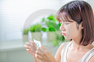 Woman use oil blotting paper photo