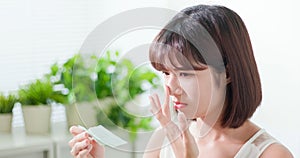 Woman use oil blotting paper photo